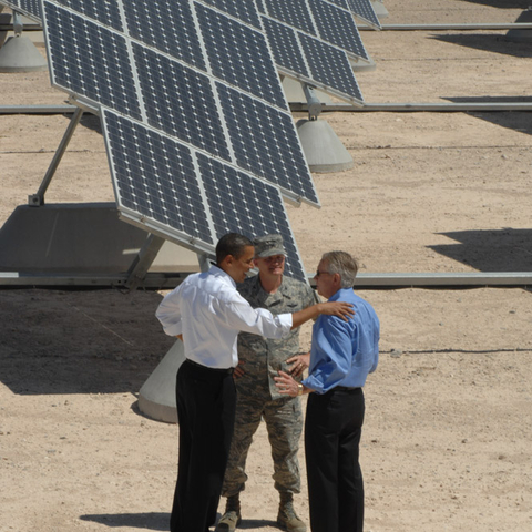 President Barack Obama, Col. Dave Belote, and Sen. Harry Reid tour the Nellis Air Force Base photovoltaic array. The largest solar energy field in the Western Hemisphere, it has over 72,000 solar panels which save the base approximately $1 million a year in energy costs.