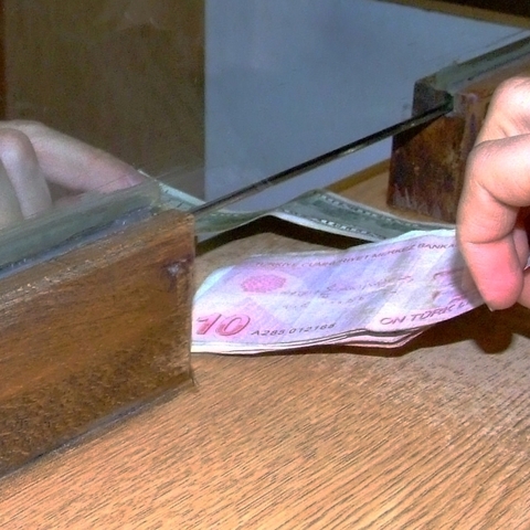 Exchanging Turkish lira for dollars at an exchange office in Turkey