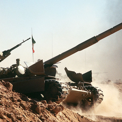 A Kuwaiti M-84 main battle tank crosses a trench during a capabilities demonstration at a Kuwaiti outpost during Operation Desert Shield.
