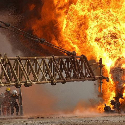 Firefighters attempt to extinguish a fire at the Rumaila Oilfield in Iraq during Operation Iraqi Freedom on March 27, 2003.