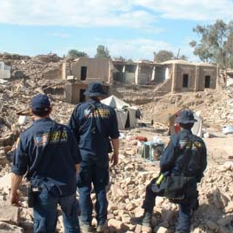 American relief workers survey earthquake damage and assist relief efforts following a 2003 earthquake in Bam, Iran.