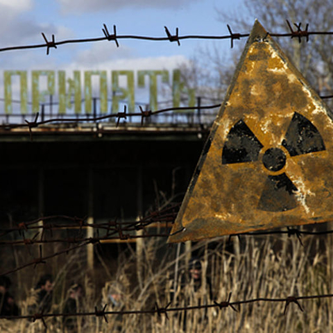 A sign depicting radioactivity hangs outside a café in the abandoned town of Pripyat near Chernobyl, Ukraine
