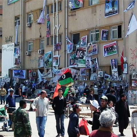 The courthouse square in Benghazi was an informal home to demonstrations and organizations against Qaddafi in April 2011. The walls of the courthouse are covered with photos of rebel casualties.