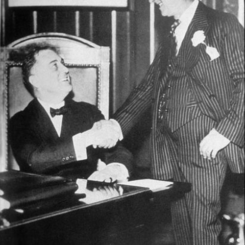 Franklin Delano Roosevelt shakes hands with Al Smith in 1930.