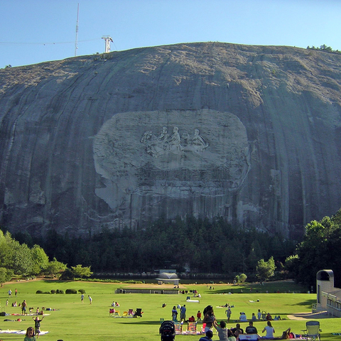 A view of the carvings on Stone Mountain, the visitor center, and the surrounding park.