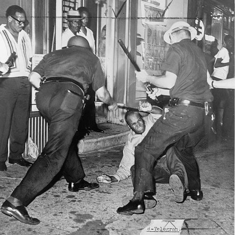 Police confront a demonstrator during the Harlem Riots of 1964.