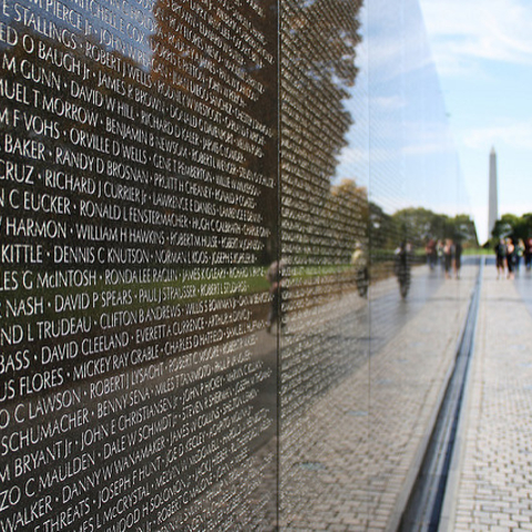 The Vietnam Veterans Memorial with the Washington Monument in D.C. in the background.