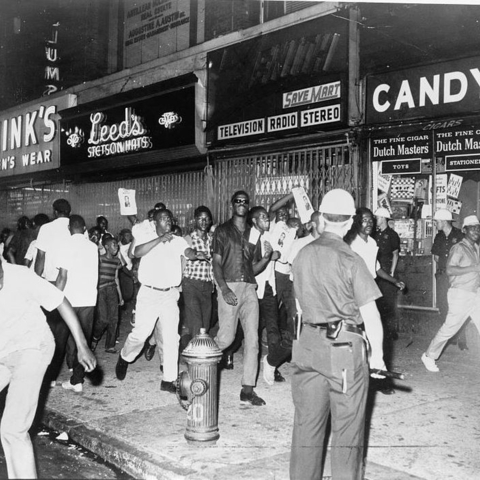 During the Harlem Riots of 1964, demonstrators carry leaflets of Lieutenant Thomas Gilligan who shot and killed 15-year-old James Powell, a black student.