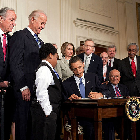 Barack Obama signs the Patient Protection and Affordable Care Act.