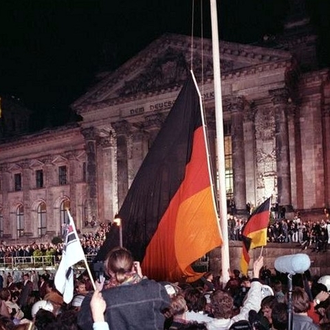 Germans raise the German Flag in front of the Reichstag.