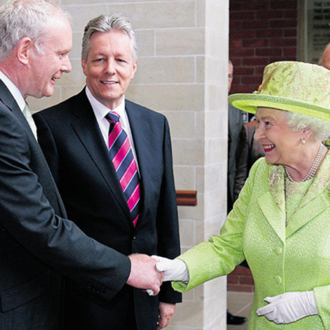 Queen Elizabeth II and Martin McGuiness shake hands.