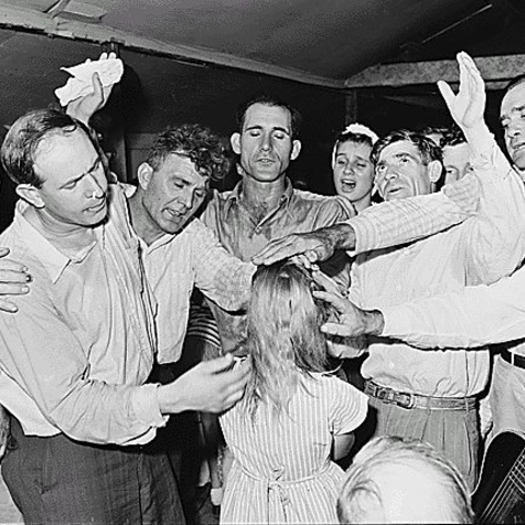 Members of a Pentacostal church practice a healing ritual.