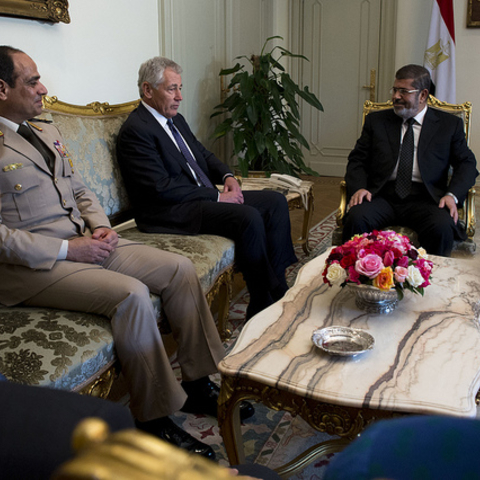 President Mohamed Morsi and General al-Sisi  listen to U.S. Secretary of Defense Chuck Hagel.