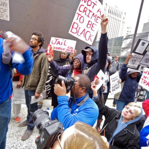 Demonstrators in Chicago hold up bags of Skittles as a symbol of Trayvon Martin's wrongful death.