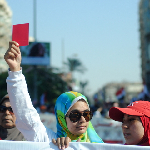 Protestors waved red cards at Morsi during a demonstration.