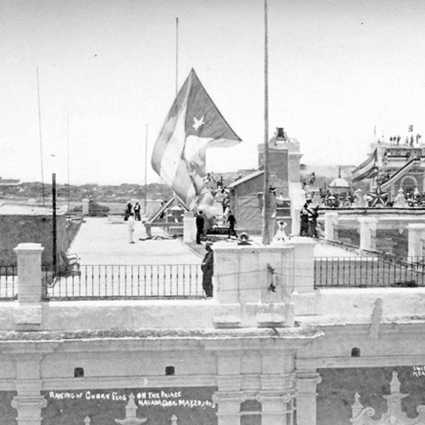 Cubans raising the national flag over the Governor General's Palace in 1902.
