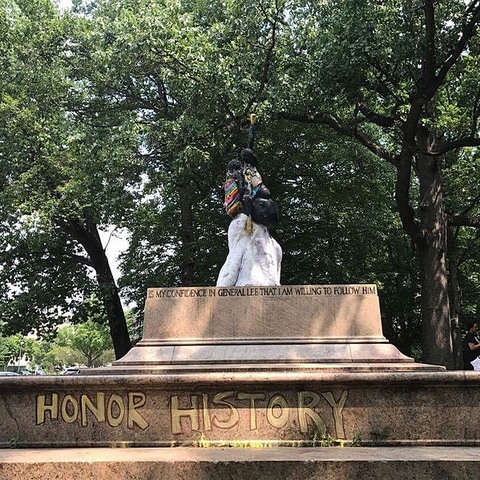 Protest art atop the pedestal of the deposed statues of Stonewall Jackson and Robert E. Lee.