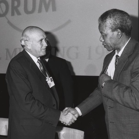 South African President Frederick de Klerk and Nelson Mandela shaking hands.