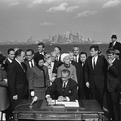 President Lyndon B. Johnson signs the Hart-Cellar Act of 1965.