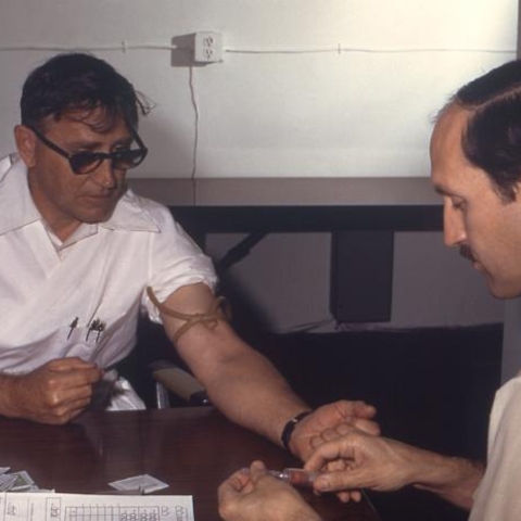 Dr. Gary Noble draws blood from his patient to test for antibodies to the H1N1 strain of influenza, 1976.