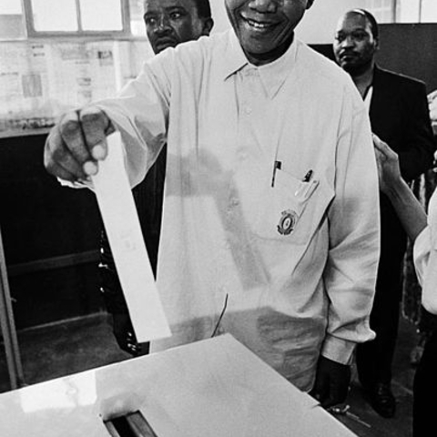 Nelson Mandela casting his ballot for the first time in his life.