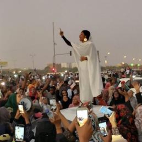A Sudanese student leading protesters in song in 2019.