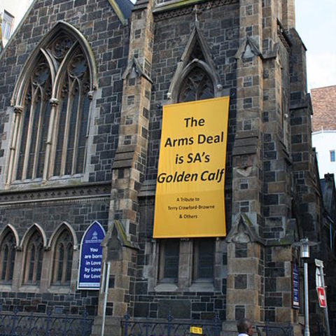 A banner on a Cape Town church criticizing an arms deal.