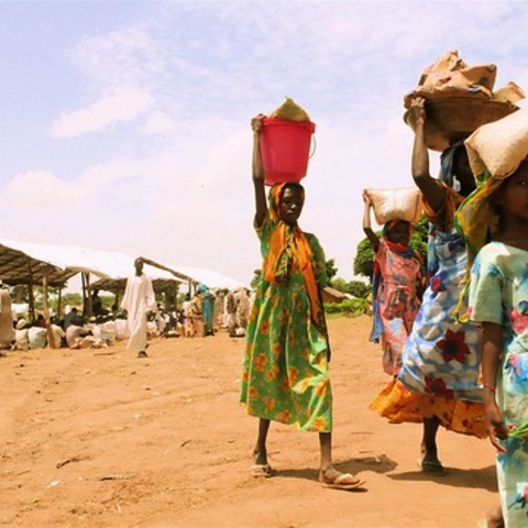 Darfur refugees carrying food home from a World Food Program center.