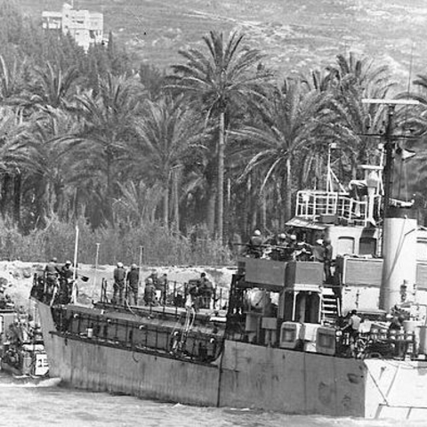 Israeli armored vehicles exit a landing craft.
