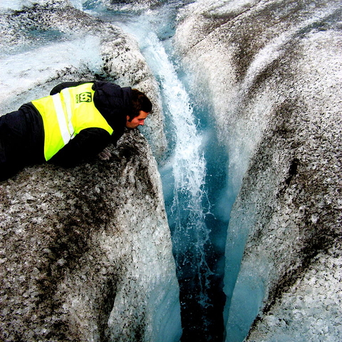 A crevasse created by water drilling a hole into the glacier ice.