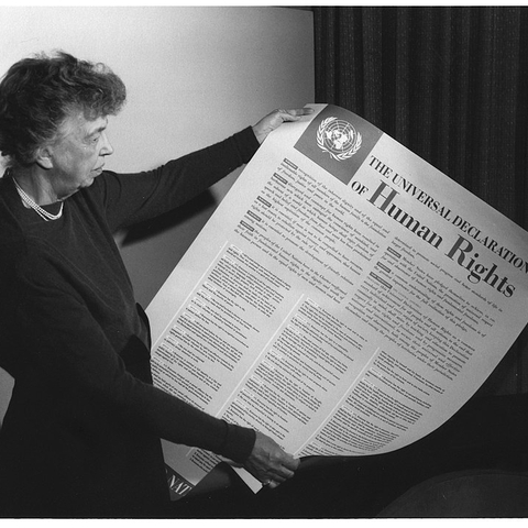 Eleanor Roosevelt holding a poster of the Universal Declaration of Human Rights.