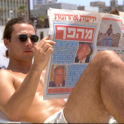 A man reads election results on a Tel Aviv beach in 1992.