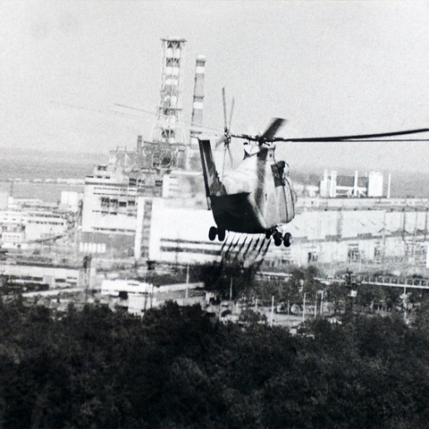 A helicopter sprays a decontamination liquid near the Chernobyl reactor.