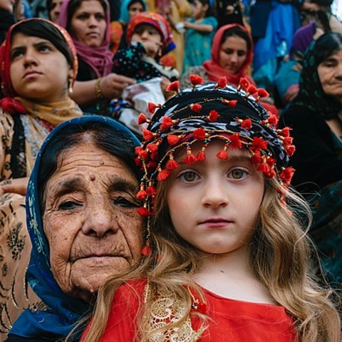 A Kurdish woman with her granddaughter at a 2017 Nowruz (Persian New Year) celebration.