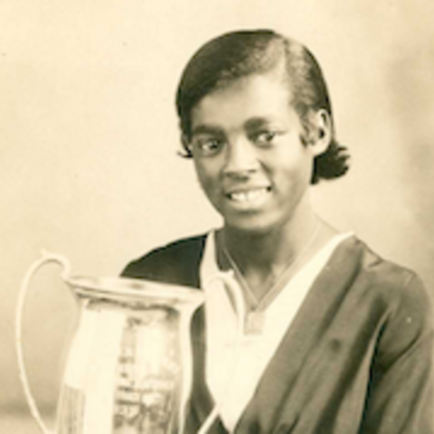 Louise Stokes holding a track meet trophy.
