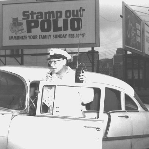 The billboard in the background of this 1963 photo is from the Polio Eradication Campaign of the early 1960s.