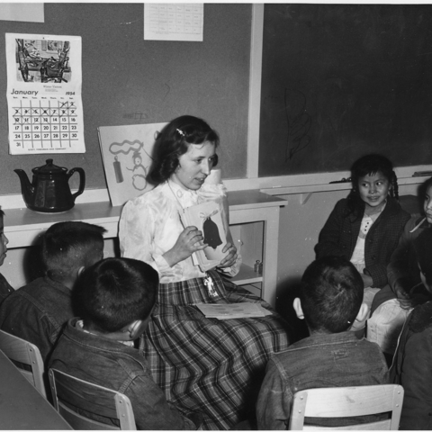 A white teacher at a Navajo day school gives English instruction.