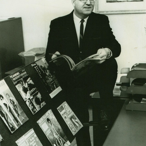 Gil Thurman of Dayton vice squad poses with magazines in 1967.