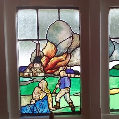 Stained glass window representing the burning of the Westhoughton Mill.