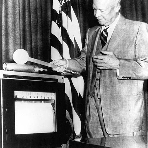 President Dwight David Eisenhower waved a ceremonial 'neutron wand' over a neutron counter.