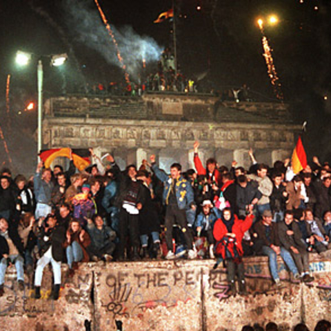 Residents of Berlin celebrate as the Berlin Wall falls.