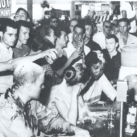Bystanders taunt civil rights activists during a lunch-counter sit-in.