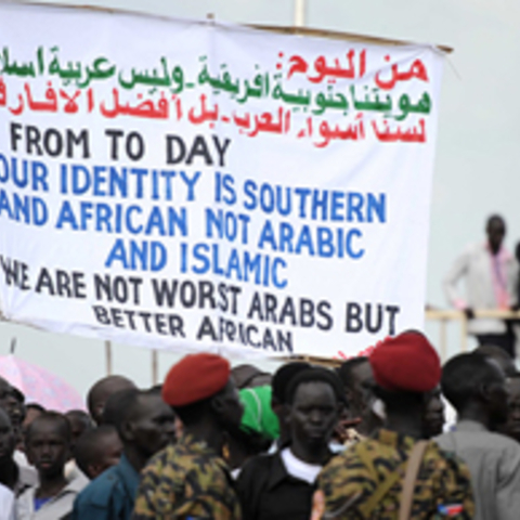 people holding sign - from today our identity is Southern and African not Arabic and Islamic