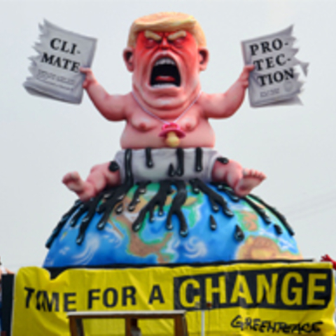Trump Baby Sculpture with sign that reads time for a change