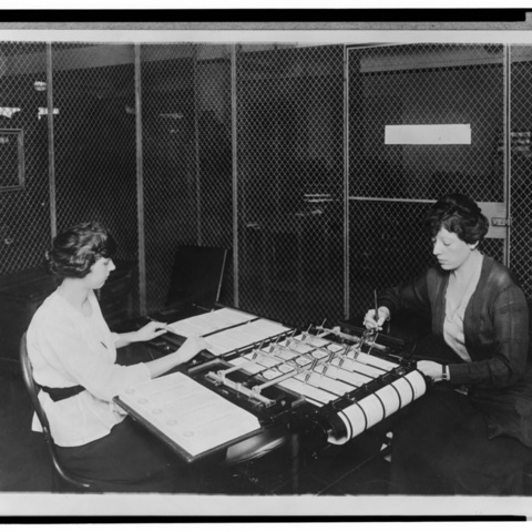 Two women process checks from the Bureau of War Insurance