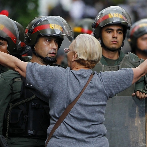 A protestor attempting to block the police during a 2017 demonstration against the government.