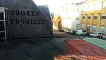 Graffiti on wall: "Broken Promises"
